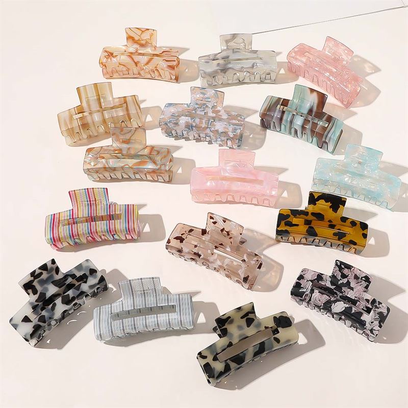 The SOHO Aria Hair Claw - Blush by SOHO features a rectangular acetate design in a blush hue, offering a stylish touch to your look.