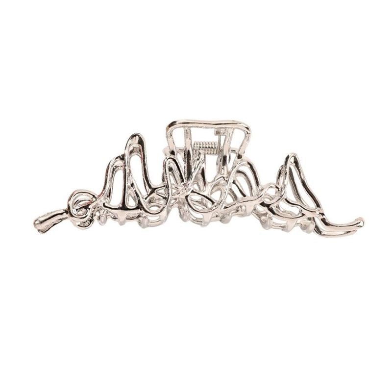 The SOHO Asli Metal Hair Claw in silver features a modern, abstract wavy open geometric design, shown against a plain white background.