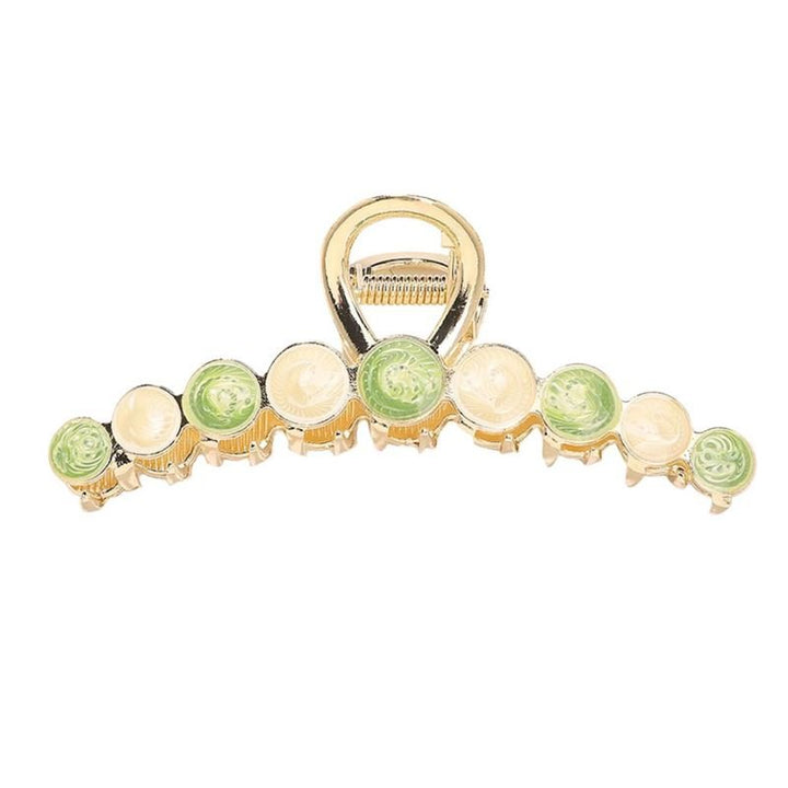 The SOHO Becca Hair Claw - Lime by SOHO features round, swirled cream and light green accents along the gold clip’s edge—ideal for adding secure, stylish flair to your hairstyle.
