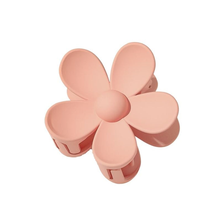 The SOHO Bloom Hair Claw - Peach by SOHO features a beige pink blossom shape with five rounded petals and a cute center—an adorable hair accessory for any occasion.