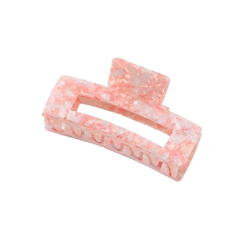 The SOHO Clara Hair Claw - Light Coral is an XL rectangular hair clip with a pink and white marbled design, hollow center, and interlocking teeth, ideal for thick hair, shown against a plain white background.
