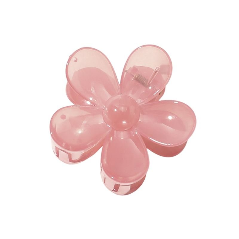 The SOHO Fiore Hair Claw in Charm Pink features a translucent, six-petaled flower design—an elegant accessory by SOHO to enhance any hairstyle.