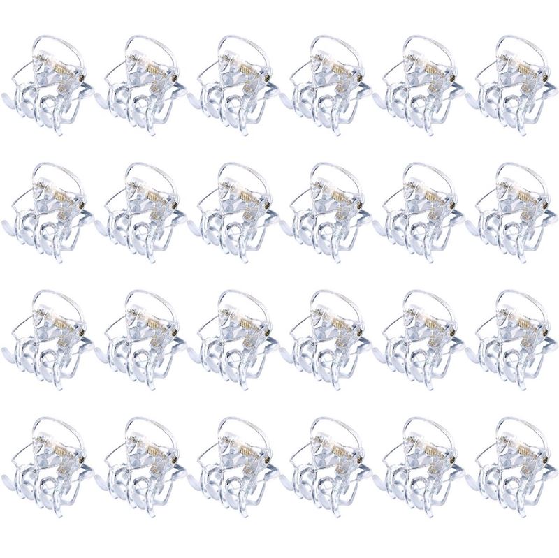 Twenty SOHO Lucca Mini Hair Claws - Transparent by SOHO, each featuring a silver metal spring and open to display their teeth, are arranged in a 4x6 grid on a white background.
