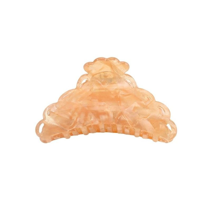 The SOHO Naomi Hair Claw - Sunshine by SOHO is a peach-colored, semi-transparent clip with a scalloped design and interlocking teeth—ideal for keeping your hairstyle secure.