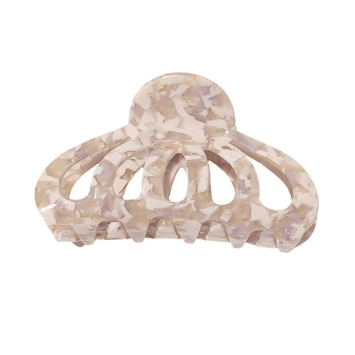 The SOHO Olivia Hair Claw - Marble is a beige and white marbled accessory with a rounded top, curved open design, and wide teeth for secure hair grip.