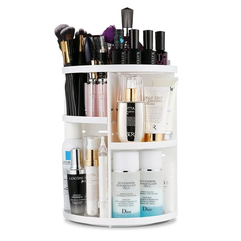 The UNIQ 360° Rotating Makeup Organizer in white by UNIQ neatly stores skincare products, bottles, makeup brushes, and nail polish on multiple shelves. It features a cosmetic storage rack, lipstick holder, and is easy to assemble.