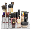 De UNIQ Acrylic Make Up Organiser 8 Compartments (ctn 07) van UNIQ biedt ruimte aan en organiseert kwasten, lippenstiften, foundationtubes, compactpoeders en kleine flesjes in aparte vakken, zodat ze gemakkelijk toegankelijk zijn.