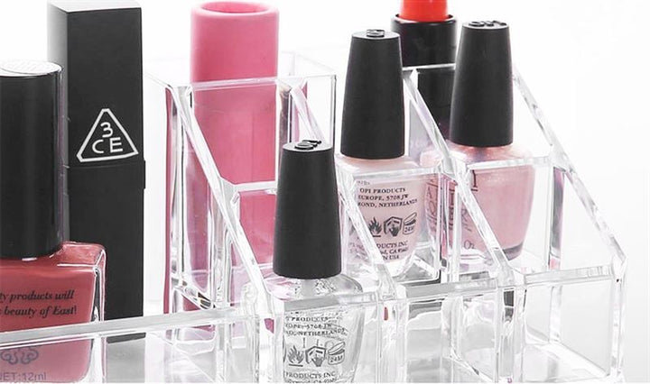 The UNIQ Makeup Acrylic Organiser with 1 drawer + top (SF-1061) by UNIQ neatly holds nail polish and makeup in pink, clear, and nude shades, with black-capped bottles and rectangular containers—ideal for stylish beauty storage.