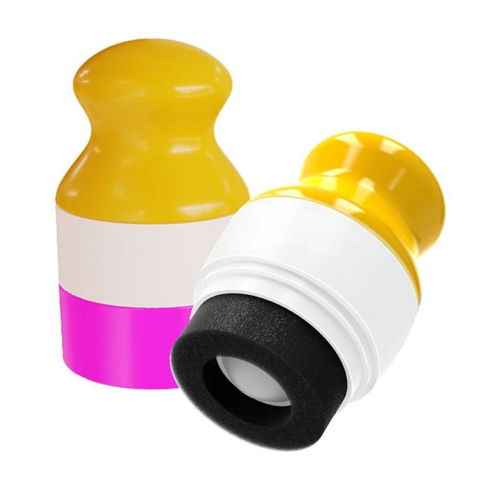 Pair your UNIQ Portable Refillable Sponge Roller Applicator (100ml) with two vibrant silicone stoppers—one upright, one lying down, each with yellow tops and colorful bases—for mess-free lotion or sunscreen storage on the go.